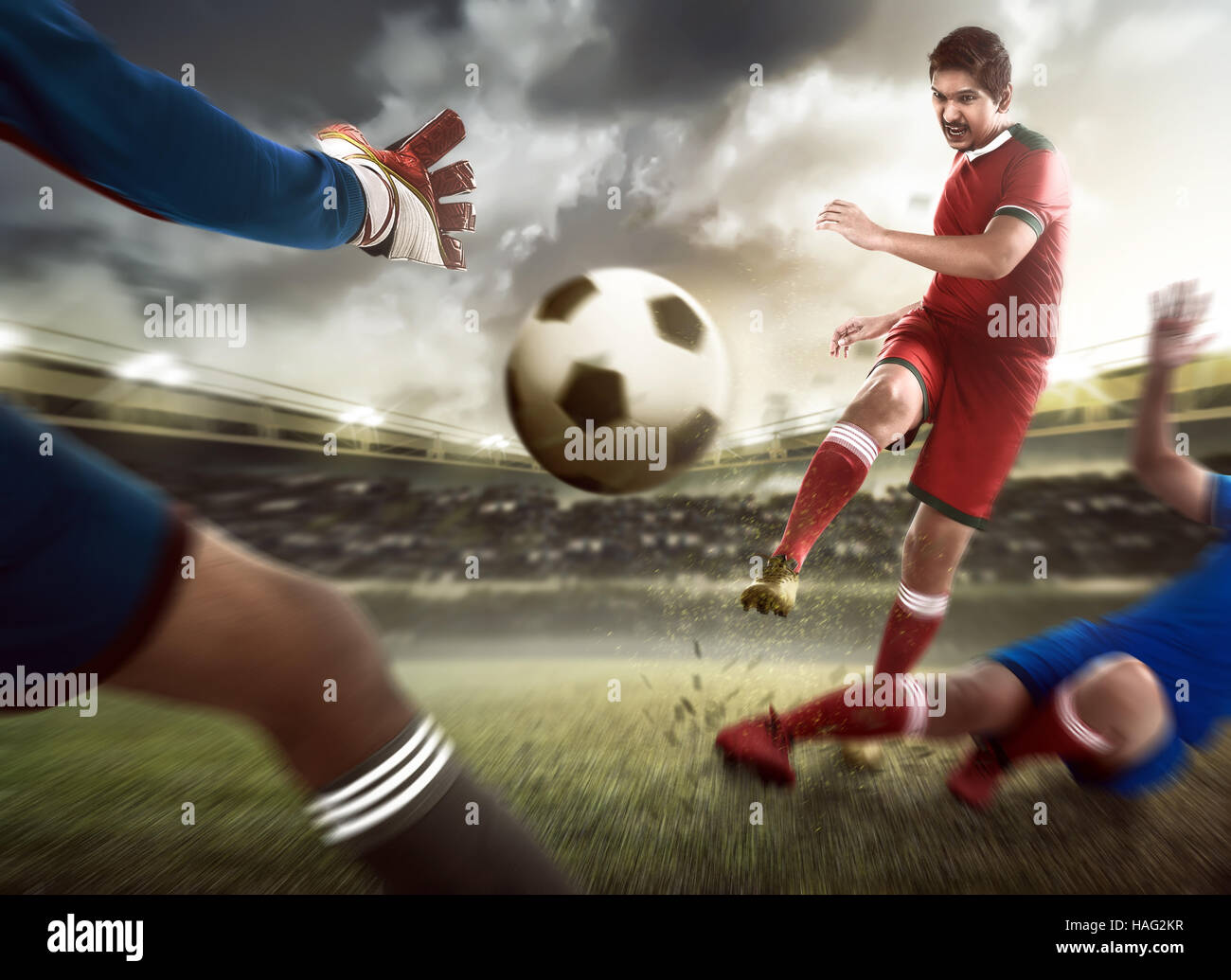 Football player kick ball and goalkeeper try to catch Stock Photo Alamy