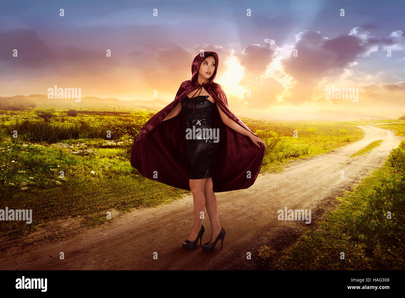 Beautiful asian witch woman with black hood on the meadow Stock Photo