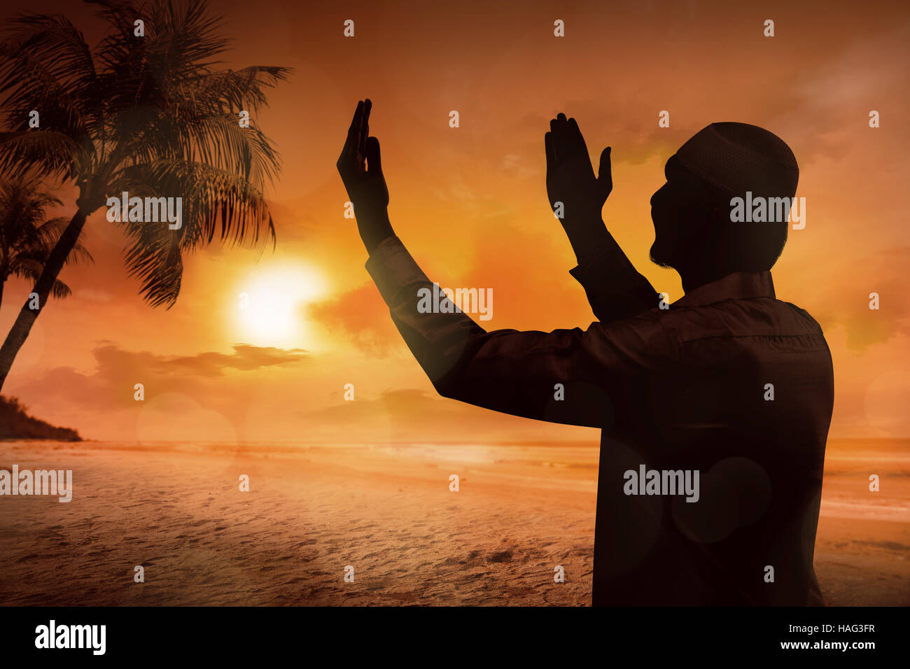 Silhouette of young muslim man praying on the beach Stock Photo - Alamy