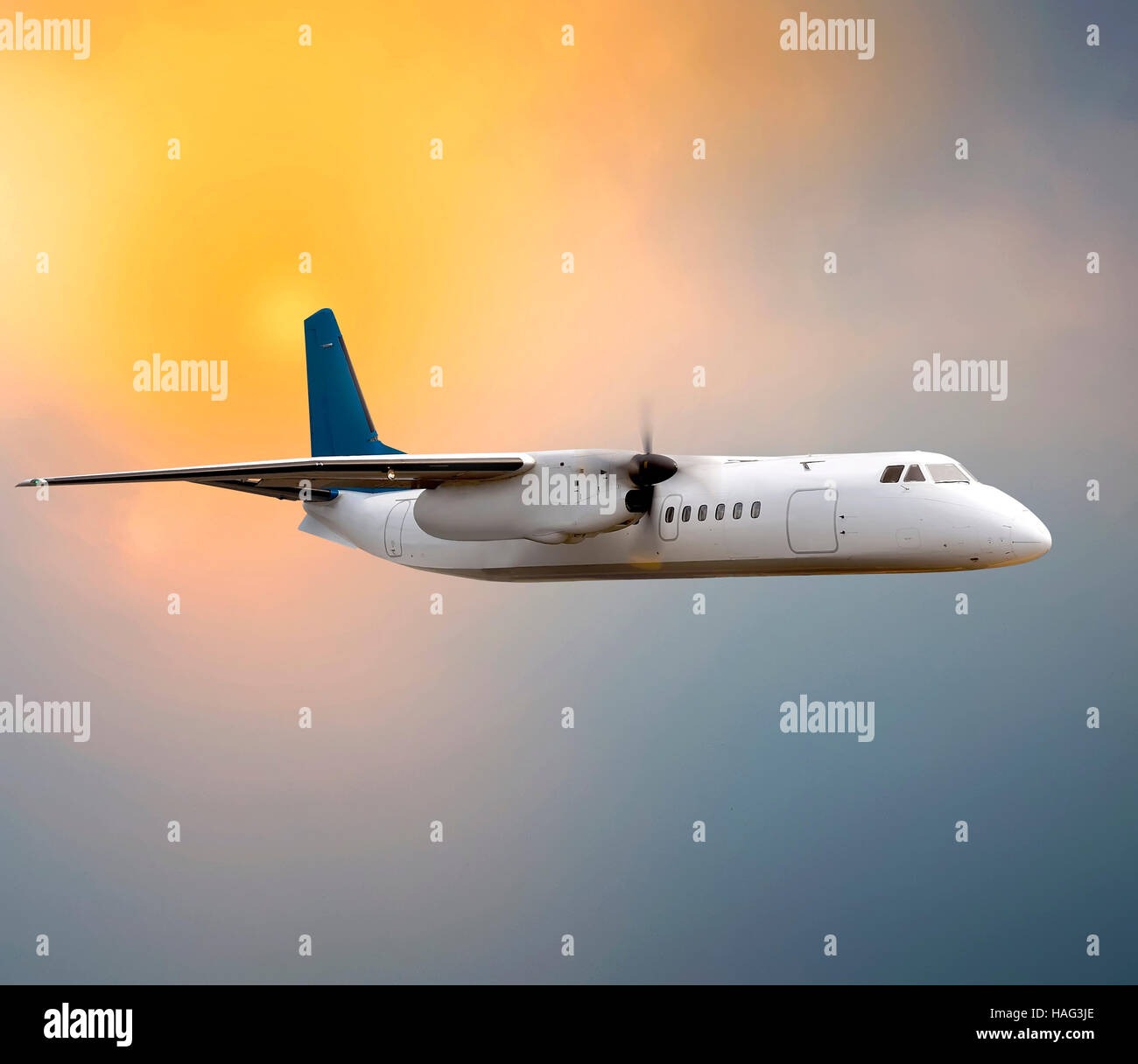 Propeller plane flying on the sunset sky Stock Photo Alamy
