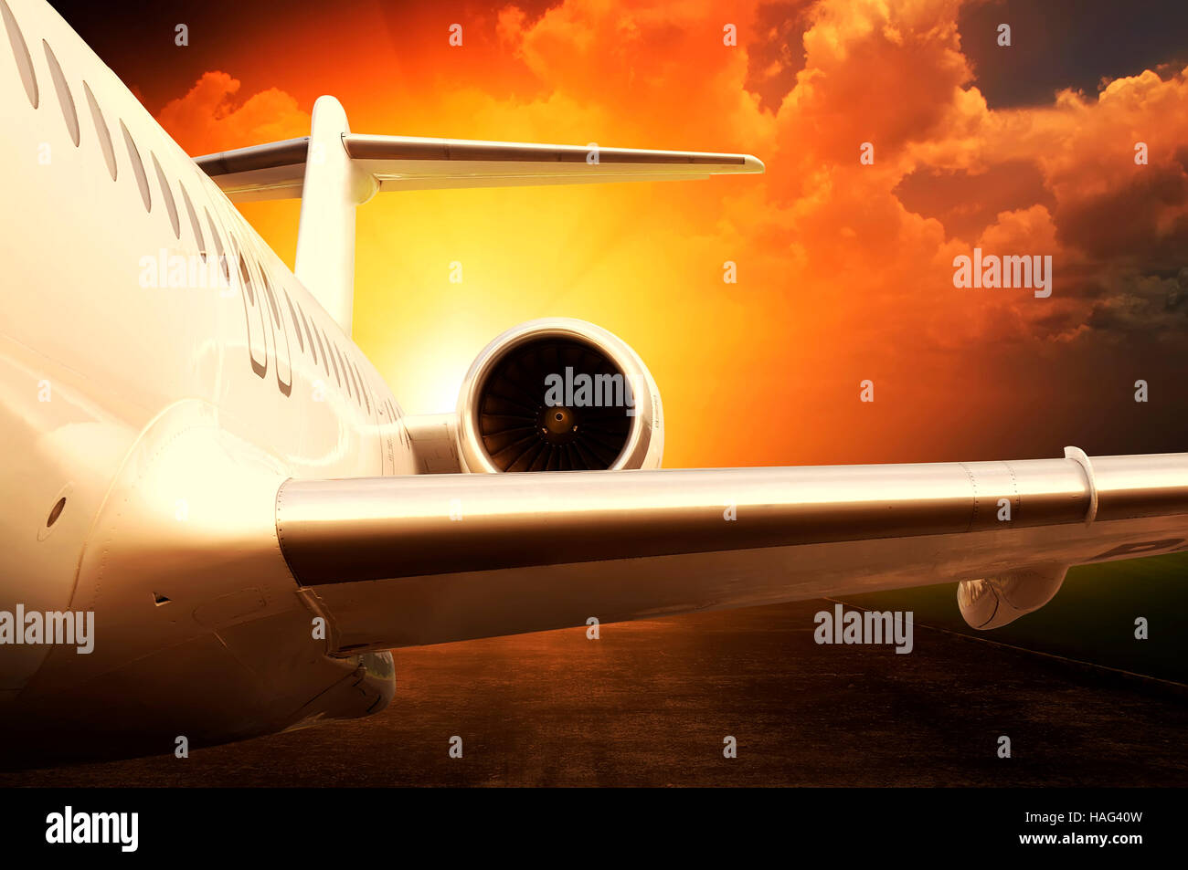 Jet engine on parked airplane over sunset background Stock Photo