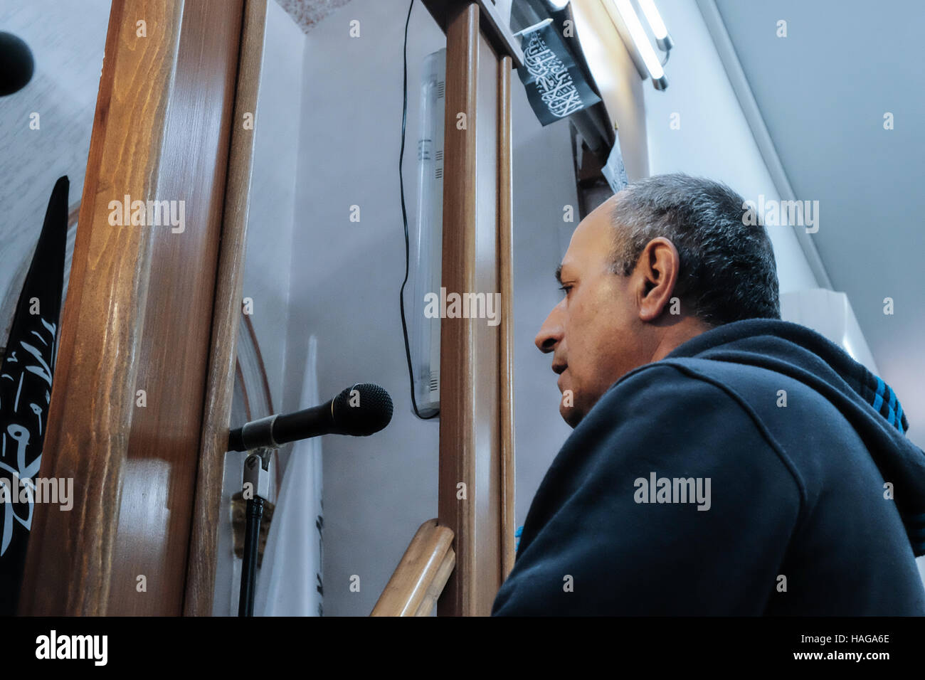 Jerusalem, Israel. 30th Nov, 2016. TAWFIK ELAYAN, Muazzin of the Al-Rahman mosque in the village of Bet Safafa, performs the 'ElAzzan', call to prayer, through a sound amplification system. The Israeli government proposed legislation to ban religious institutions from using outdoor loudspeakers, called the 'Muazzin Bill', as in the Muslim call to prayer which occurs 5 times a day. The bill, labeled a threat to the Muslim communities and a move by the Israeli government to shut down mosques, is scheduled to come up for a preliminary vote. Credit:  Nir Alon/Alamy Live News Stock Photo