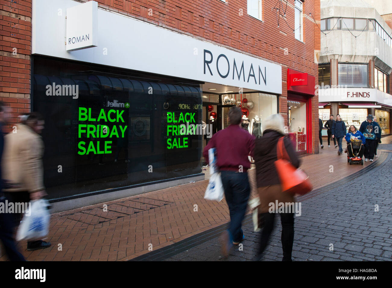 Blackpool, Lancashire, UK. 30th November, 2016. People passing Roman Black Friday Sales signage, shopper, shopping, sale, happy, female, woman, young, bag, fashion, beautiful, customer, girl, retail, lifestyle, purchase, bags, people, shopaholic, person, holding purchases.  Credit:  Mediaworld Images/Alamy Live News Stock Photo
