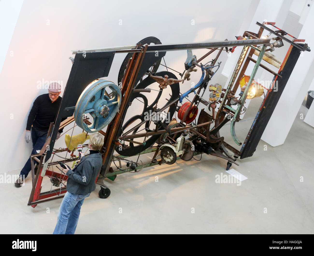 Duisburg, Germany. 01st Jan, 2016. Museum experts look at 'Maerchenrelief'by Jean Tinguely in the Lehmbruck Museum in Duisburg, Germany, 01 January 2016. The museum is exhibiting new and old works as part of a new show called 'Neuaufgestellt!' ('Restructured!'). Photo: Roland Weihrauch/dpa/Alamy Live News Stock Photo