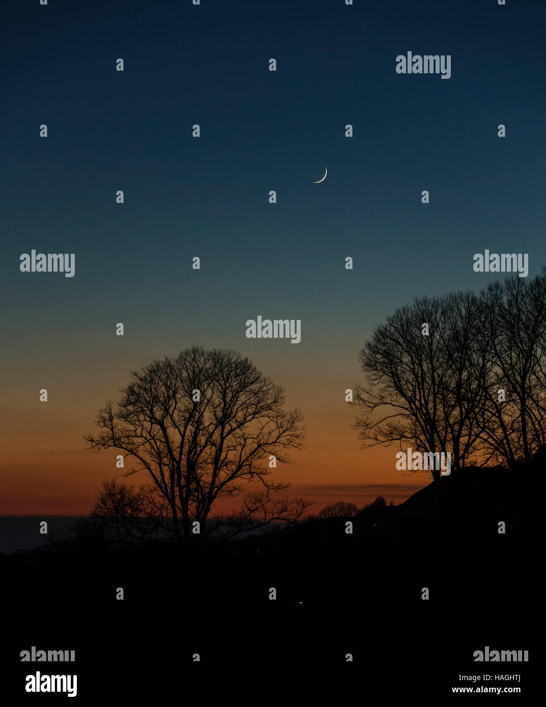 Sidmouth, Devon, 1st Dec 2016 A new crescent moon rises above the English Channel at Sidmouth Devon, at the end of a clear and frosty winter's day throughout the South West of England. Photo: Tony Charnock / Alamy Live News Stock Photo