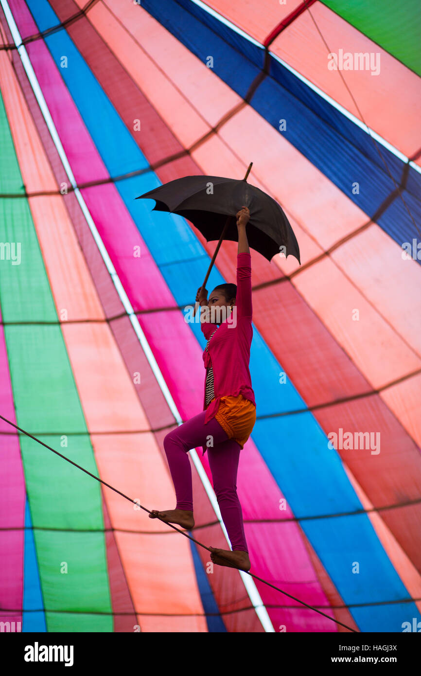 Dhaka, Bangladesh. 29th Nov, 2016. Acrobate doing trapeze inside a circus tent beside in Dhaka, Banhladesh on November 29, 2016. Circus is a popular form of entertainment for different levels of people of Bangladesh. Circus is all about fantasy. The performer entertain people showing different games including balance on rope, cycling, jump from the top, knife game and many. Some circus shows game with animals like lions, elephant, dogs, monkeys etc. circus is passing a hard time now. Credit:  zakir hossain chowdhury zakir/Alamy Live News Stock Photo