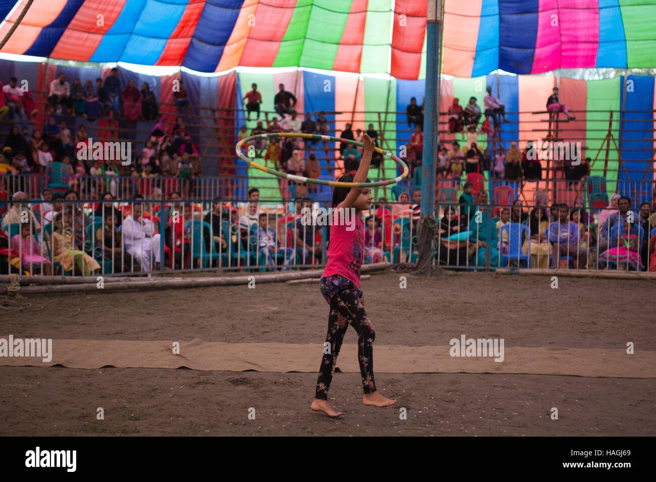 Dhaka, Bangladesh. 29th Nov, 2016. Acrobate doing trapeze inside a circus tent beside in Dhaka, Banhladesh on November 29, 2016. Circus is a popular form of entertainment for different levels of people of Bangladesh. Circus is all about fantasy. The performer entertain people showing different games including balance on rope, cycling, jump from the top, knife game and many. Some circus shows game with animals like lions, elephant, dogs, monkeys etc. circus is passing a hard time now. Credit:  zakir hossain chowdhury zakir/Alamy Live News Stock Photo