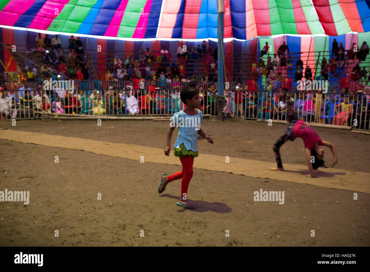 Dhaka, Bangladesh. 29th Nov, 2016. Acrobate doing trapeze inside a circus tent beside in Dhaka, Banhladesh on November 29, 2016. Circus is a popular form of entertainment for different levels of people of Bangladesh. Circus is all about fantasy. The performer entertain people showing different games including balance on rope, cycling, jump from the top, knife game and many. Some circus shows game with animals like lions, elephant, dogs, monkeys etc. circus is passing a hard time now. Credit:  zakir hossain chowdhury zakir/Alamy Live News Stock Photo