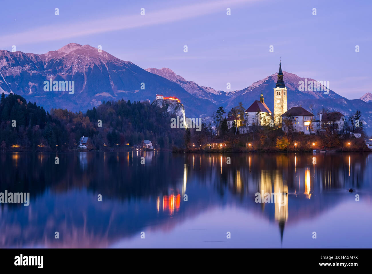 Chapel on a small island at twilight reflected in calm water, Bled, Slovenia Stock Photo