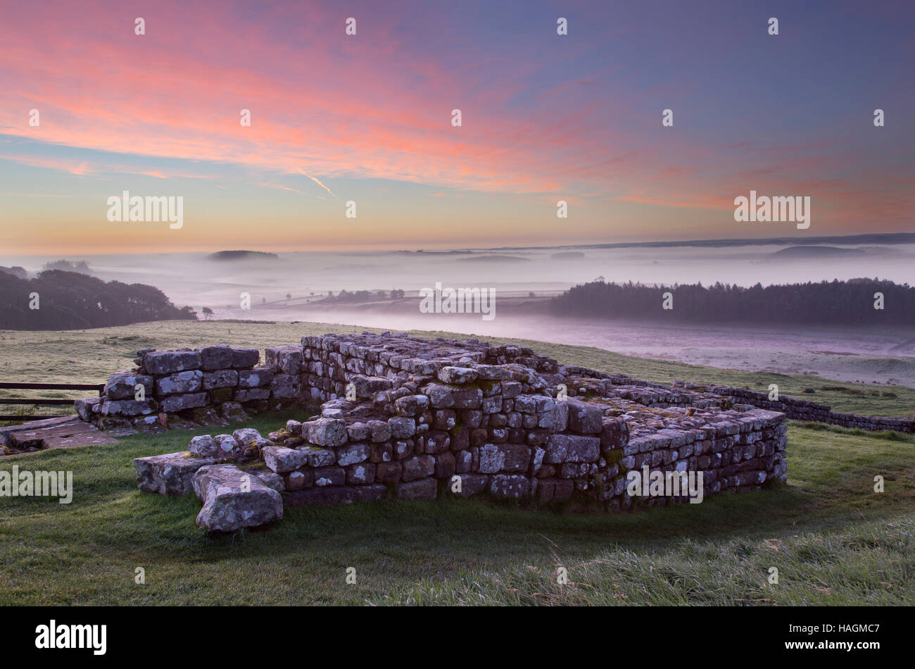 Housesteads Roman Fort, remains of the east gate, south tower seen at dawn with low-lying mists in the background Stock Photo