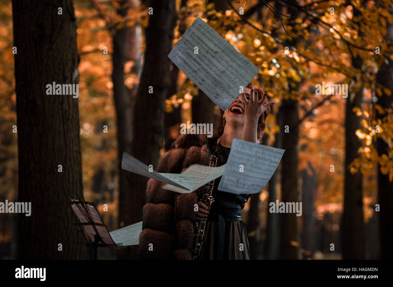 Young emotional woman throwing away the musical sheets and holding an