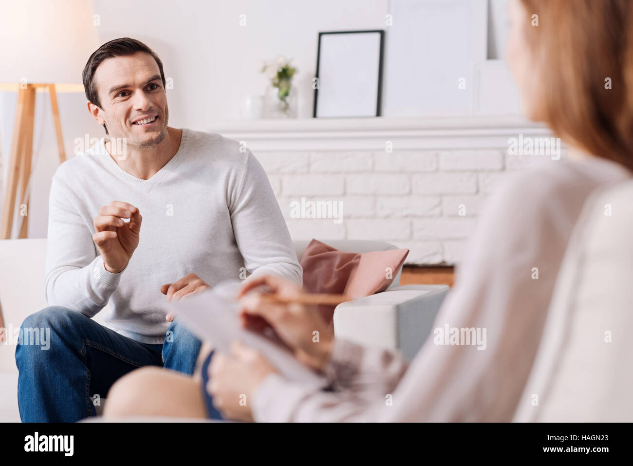 Cheerful man talking with psychologist Stock Photo
