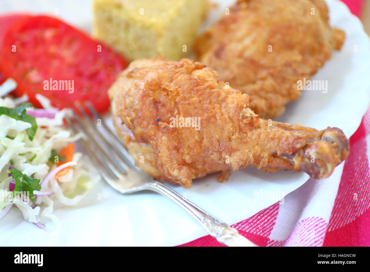 Fried chicken with coleslaw and cornbread with fork Stock Photo