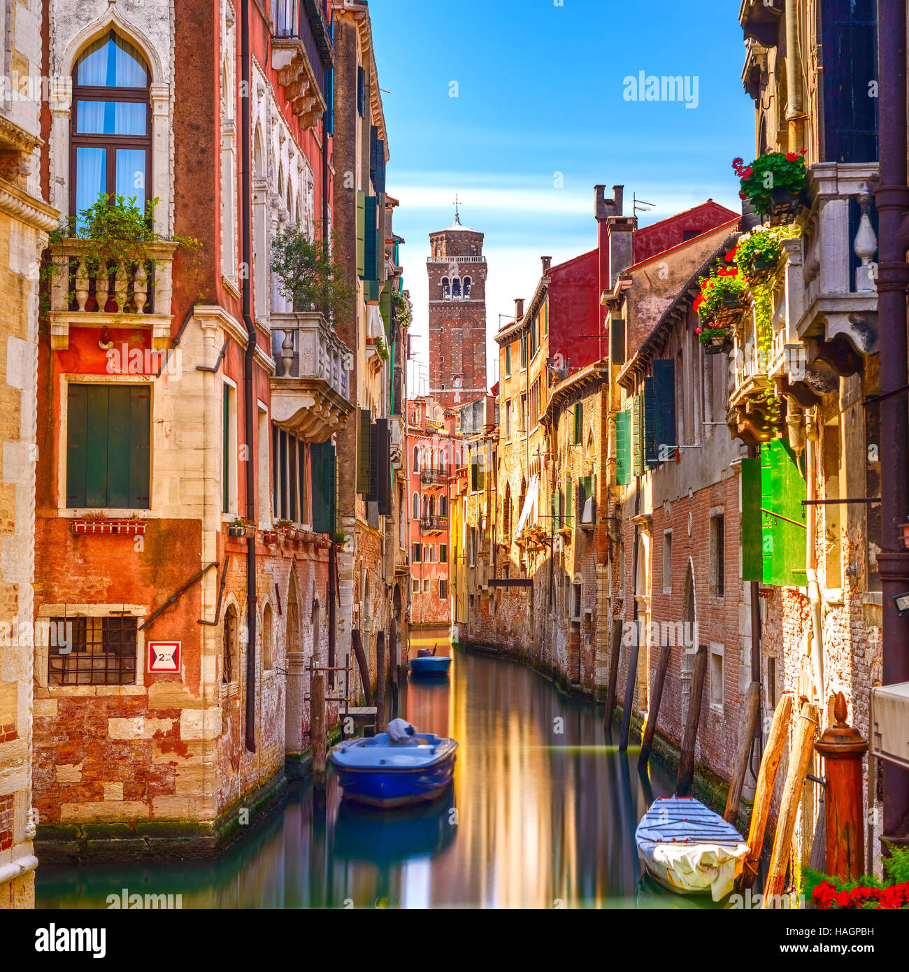 Venice cityscape, narrow water canal, campanile church on background and traditional buildings. Italy, Europe. Stock Photo