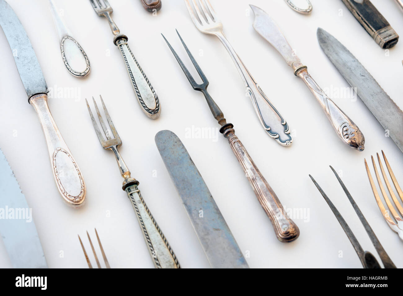 group of vintage cutlery / flatware decorated on white table cloth - restaurant table concept Stock Photo