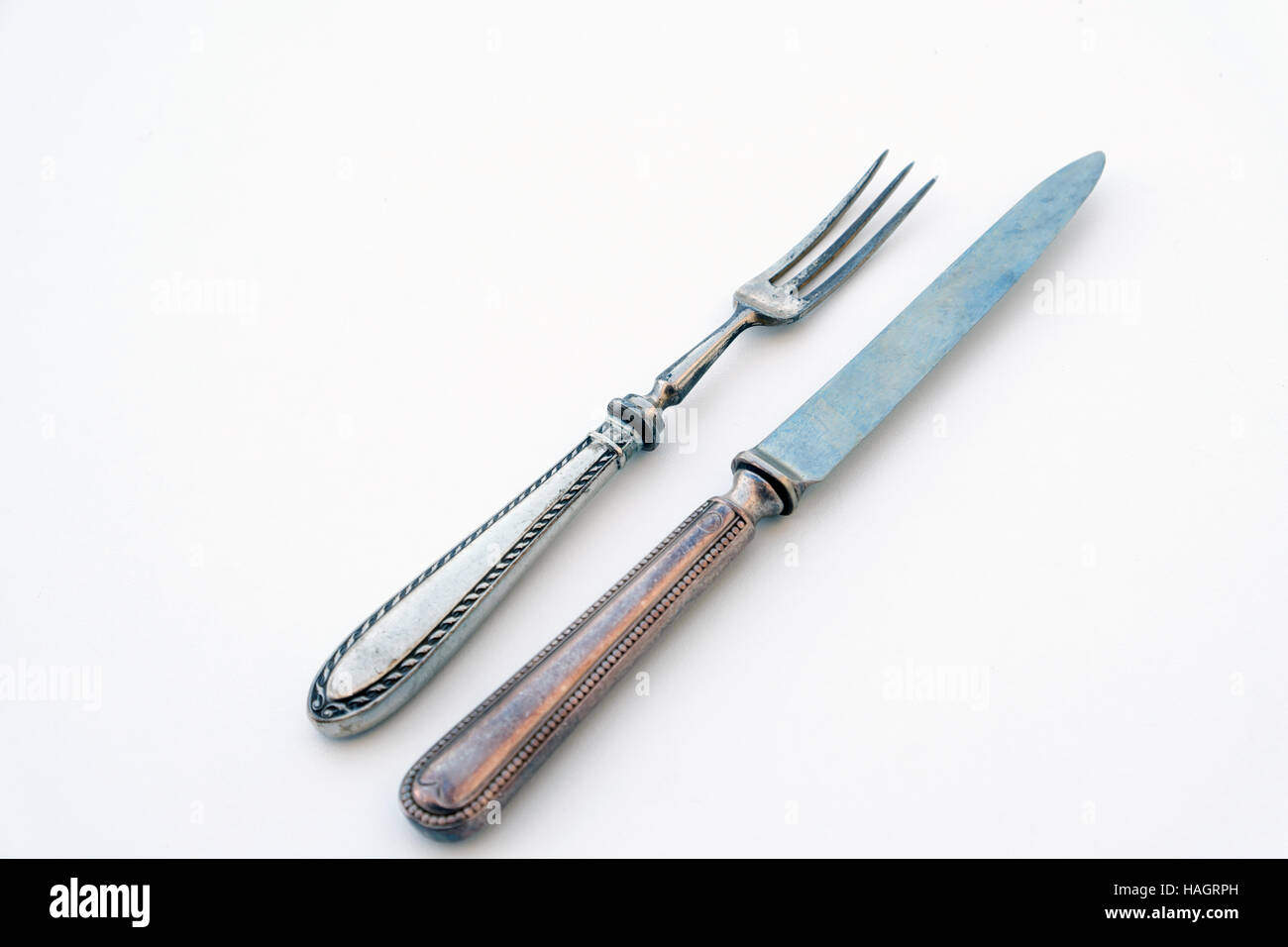 old knife and fork silver set - beautiful vintage cutlery on white table Stock Photo