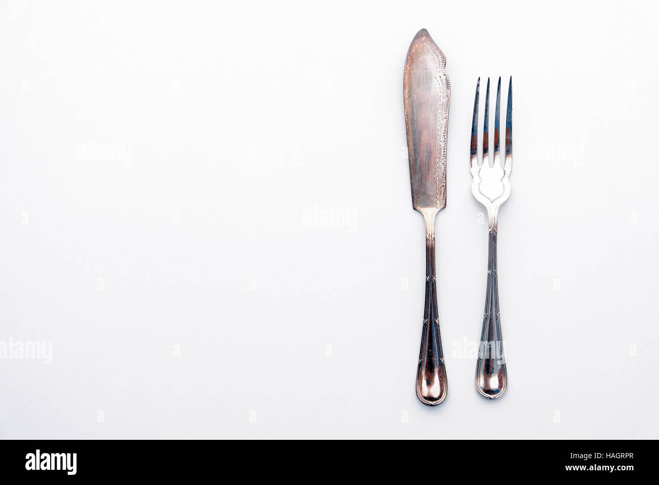 old knife and fork silver set - beautiful vintage cutlery on white table Stock Photo