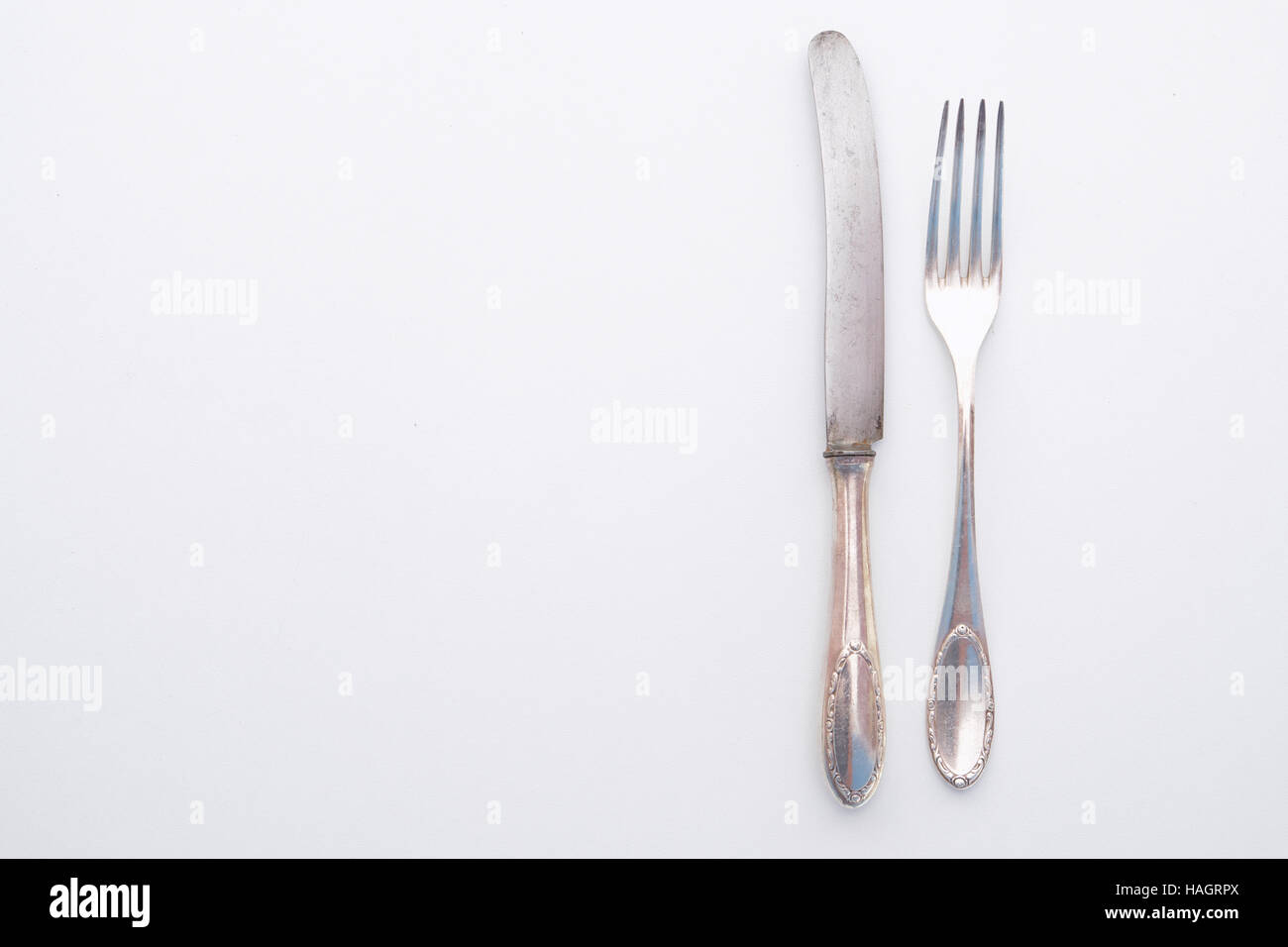 old knife and fork silver set - beautiful vintage cutlery on white table Stock Photo