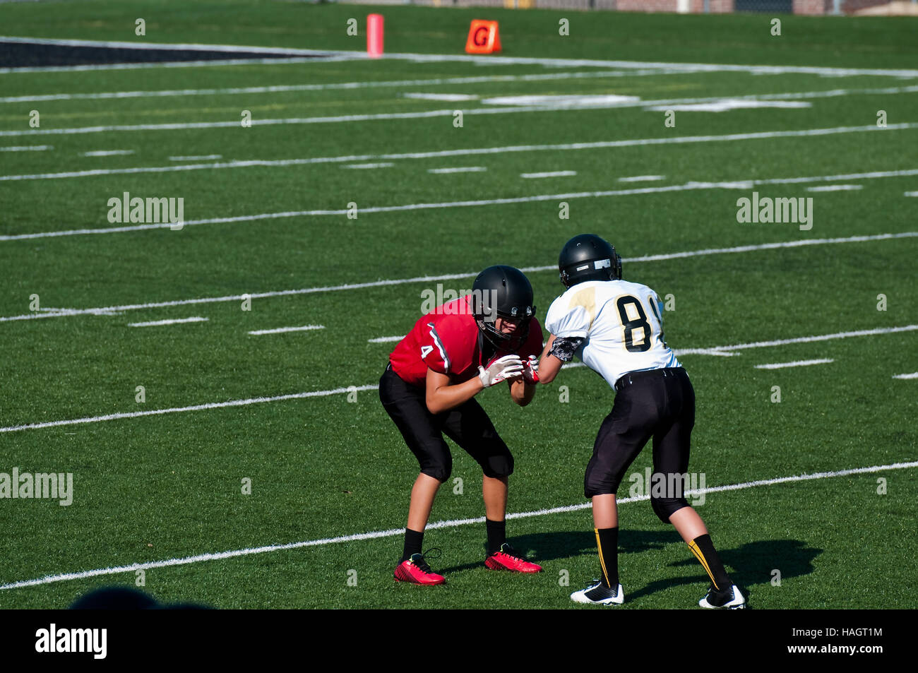 Teenage high school american football boys blocking each other on the ...