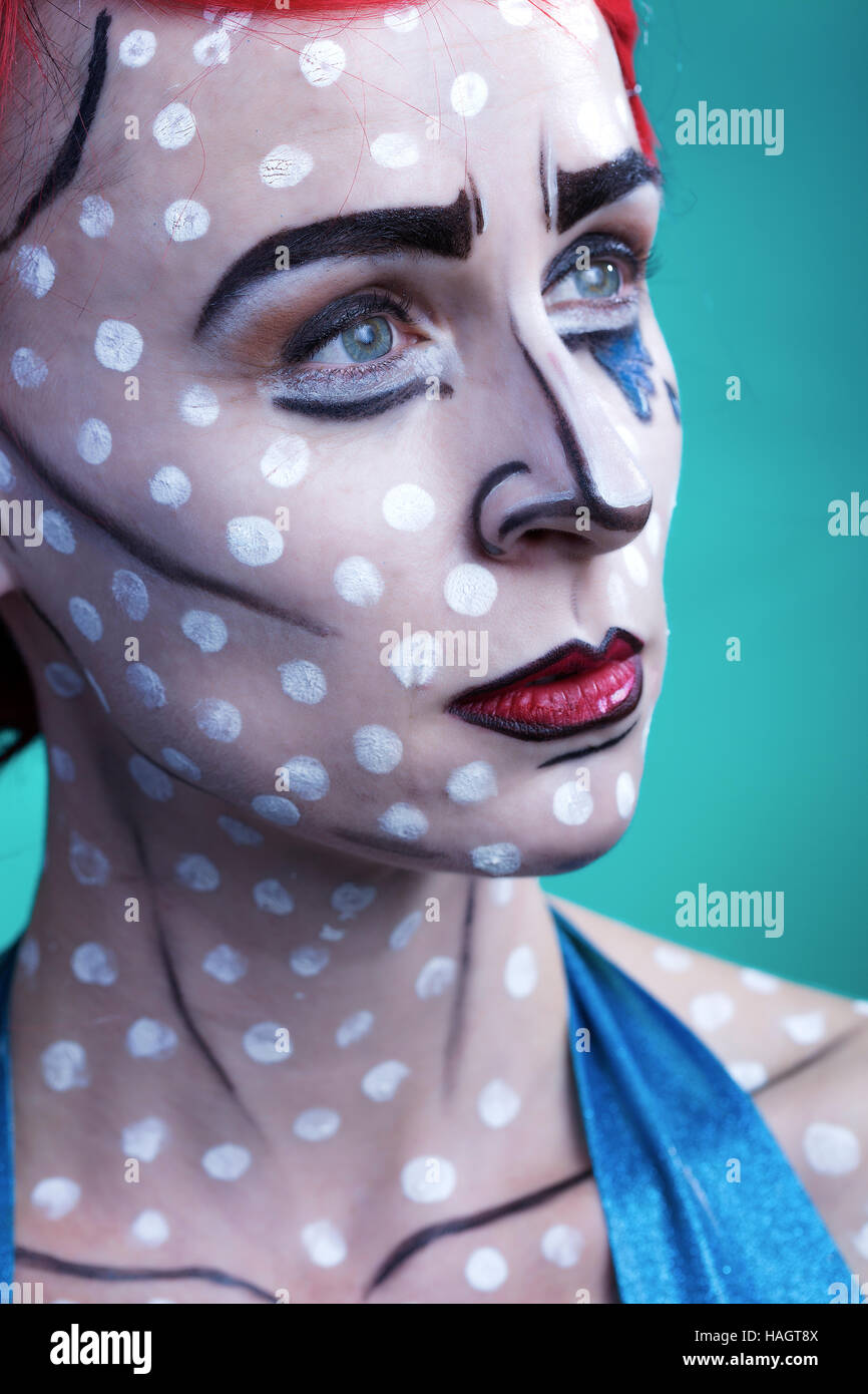 Portrait in pop art comic strip style featuring red haired woman with white dots, blue tears and contouring on skin Stock Photo