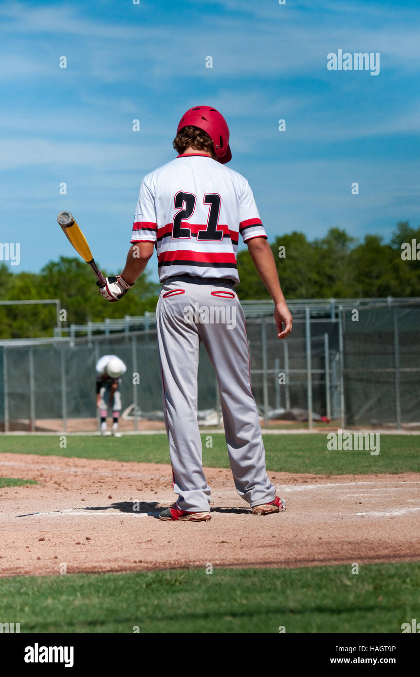Teen baseball boy standing on home plate ready to bat Stock Photo Alamy