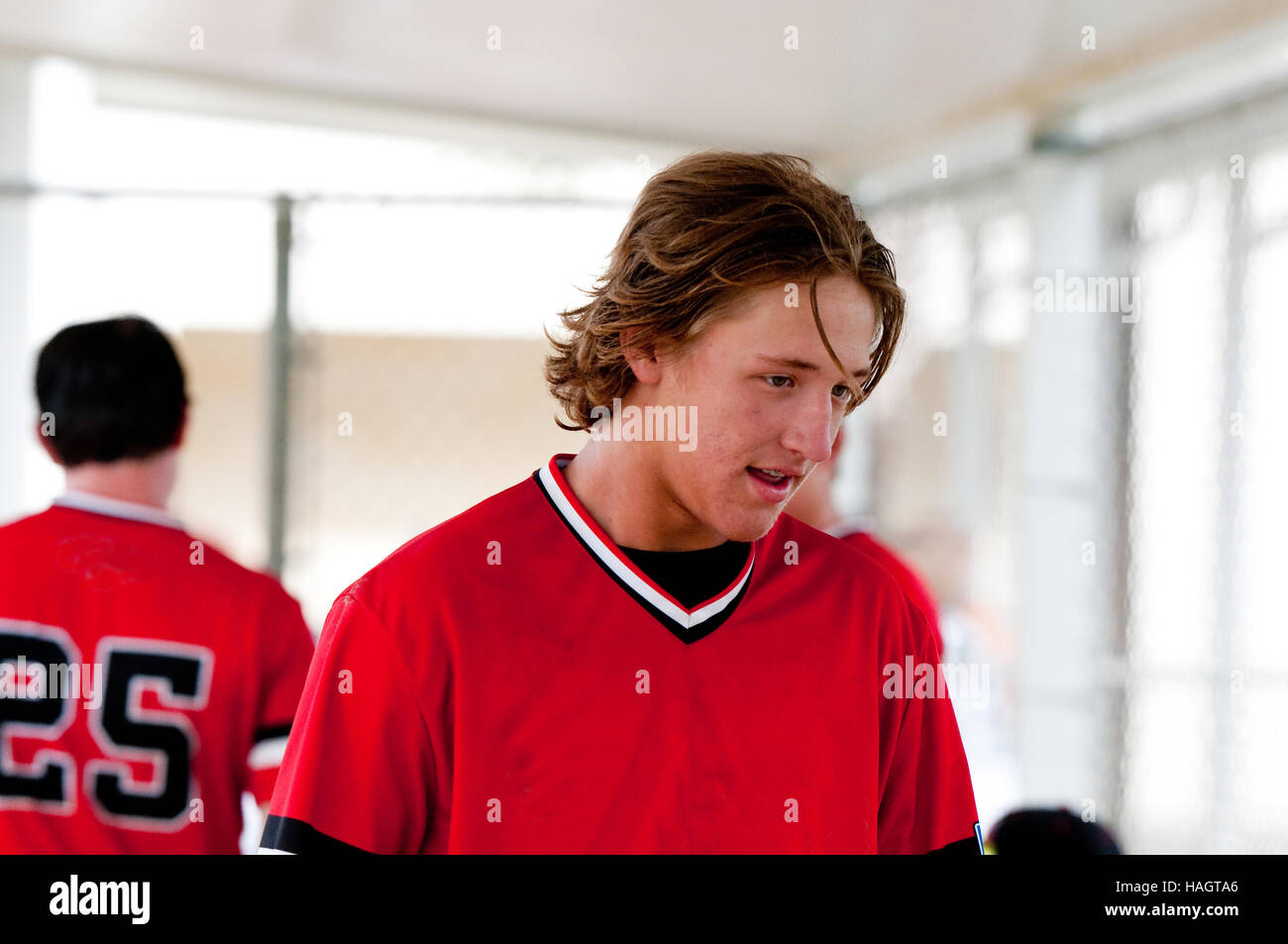 Closeup Of Baseball Player With Long Hair Smiling In Dugout Stock