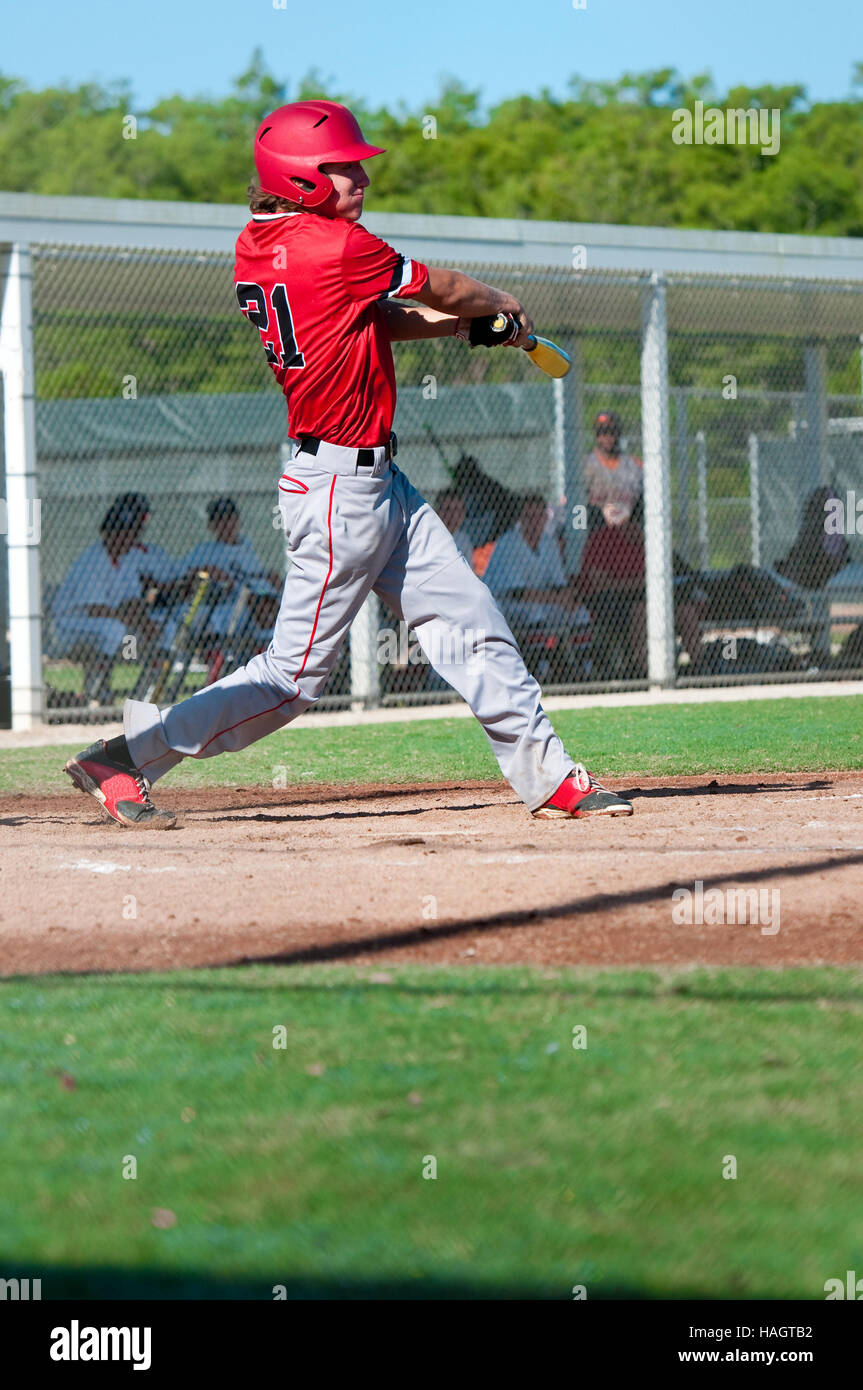 Teen baseball boy swinging bat Stock Photo Alamy