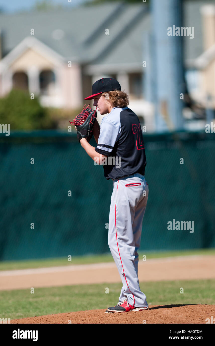 American teenage high school pitcher on the mound during a game Stock