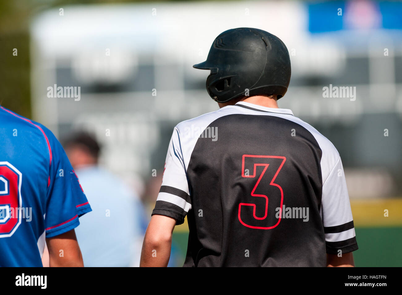 High school baseball boy standing on first base Stock Photo Alamy