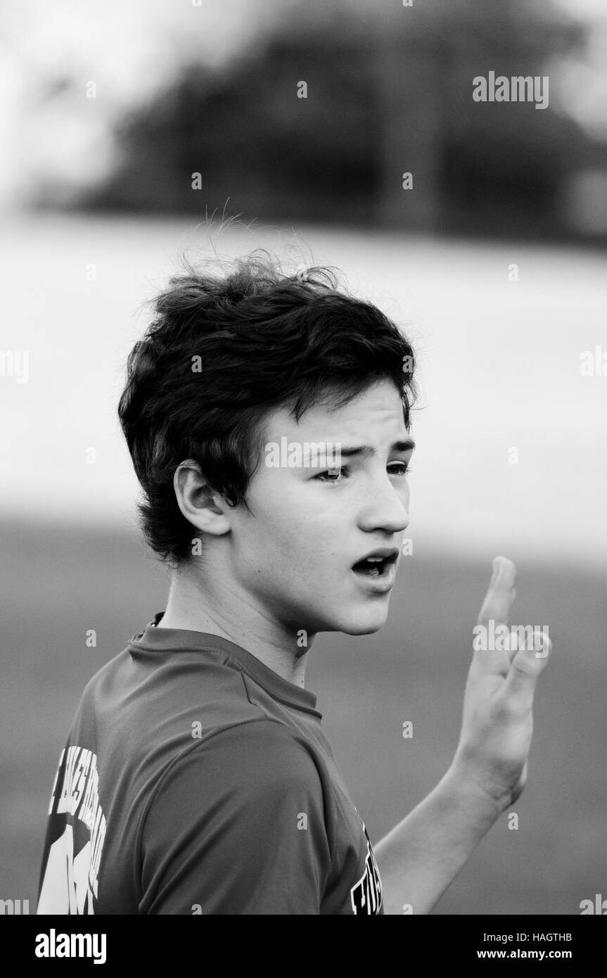 Black and white portrait of teenage boy with mouth open. Stock Photo