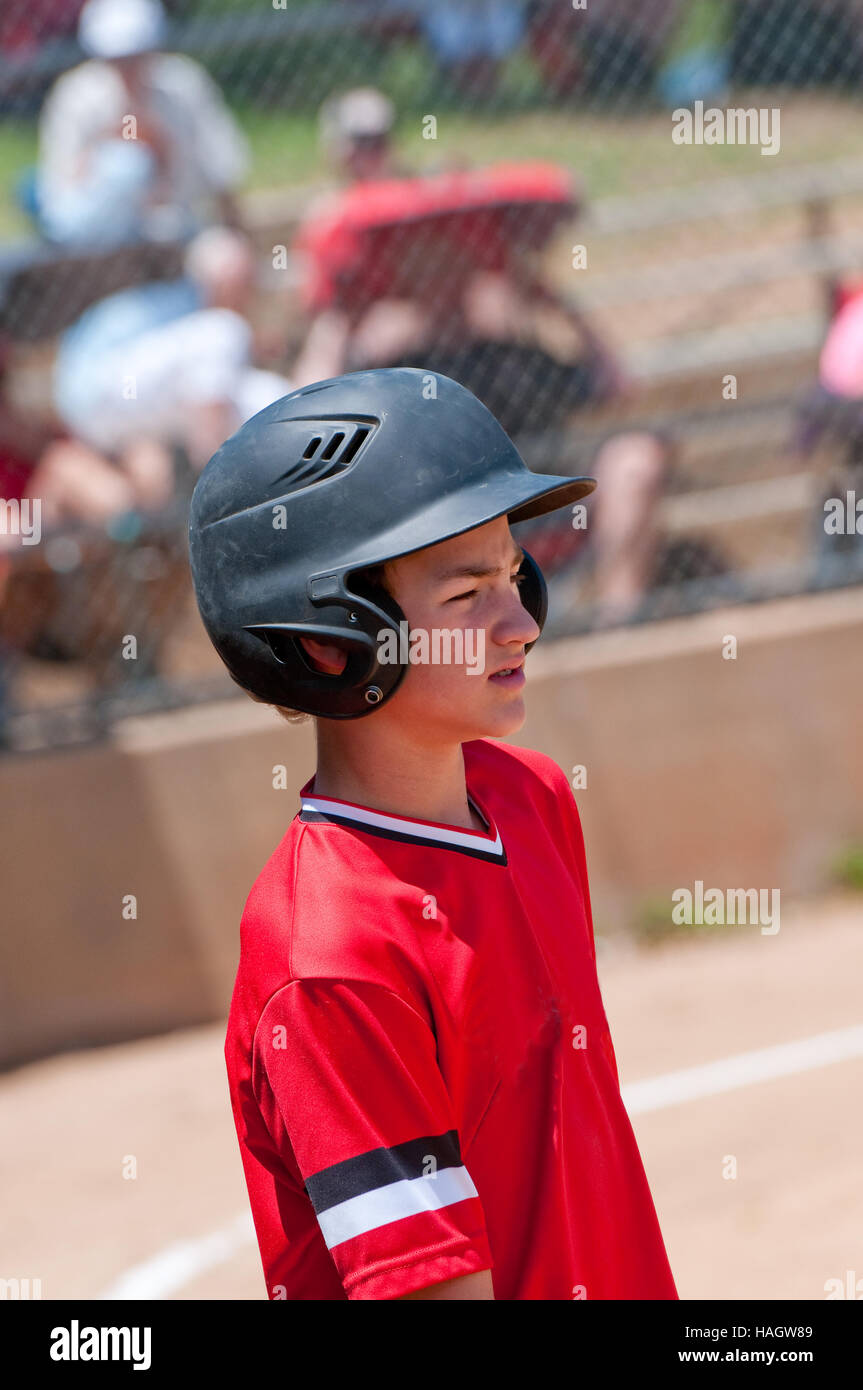 Youth baseball boy ready to bat, looking confident. Stock Photo
