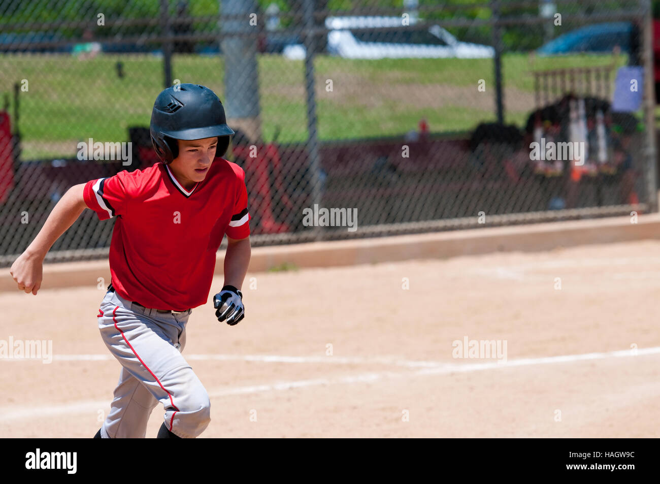 Youth teenage baseball kid running to first base Stock Photo Alamy