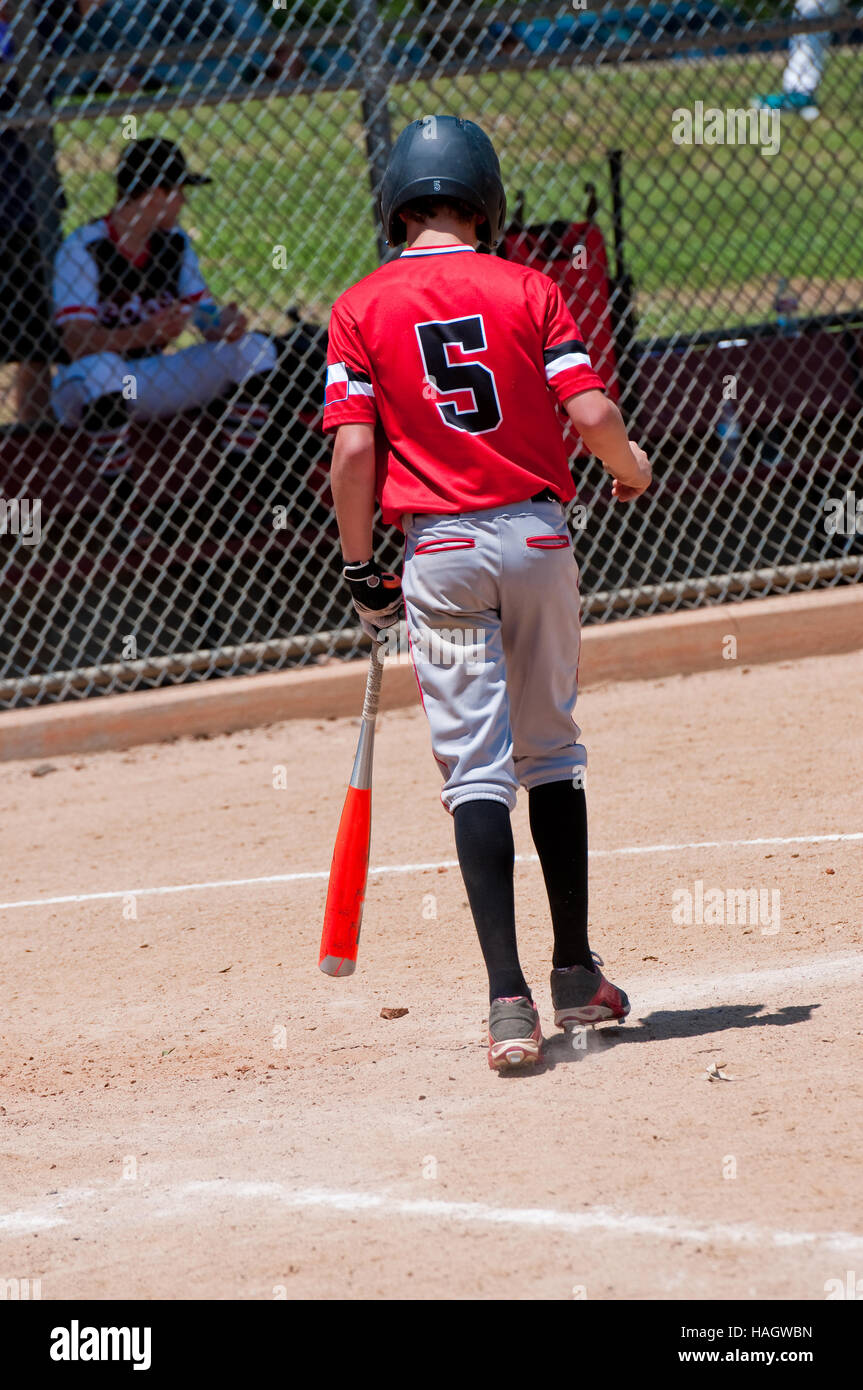 Rear view of american youth baseball boy going up to bat. Stock Photo