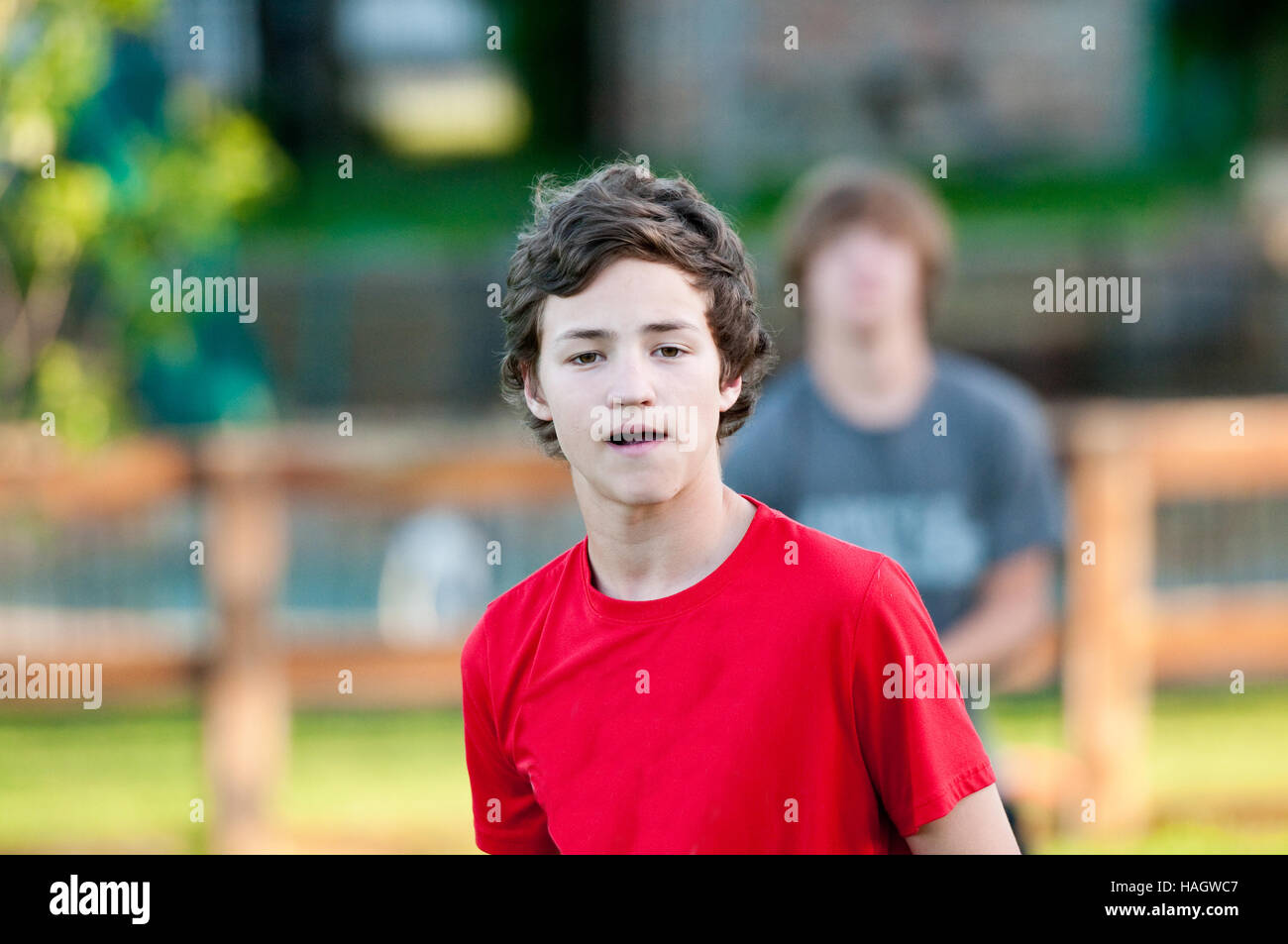 Teenage boy close-up in backyard with expression on face. Stock Photo
