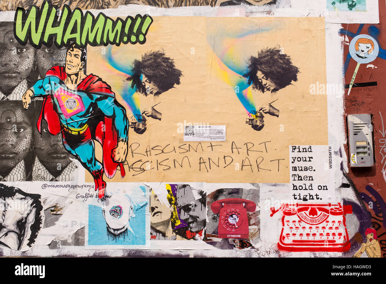 Street art graffiti and murals representing a typewriter printing words, Superman and afro girl painting a small house Stock Photo