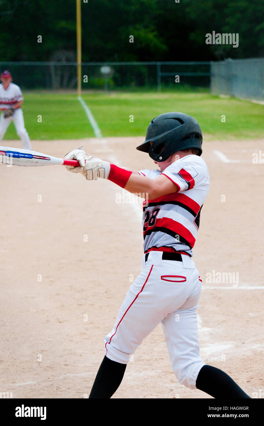 American teenage baseball player with big swing. Stock Photo