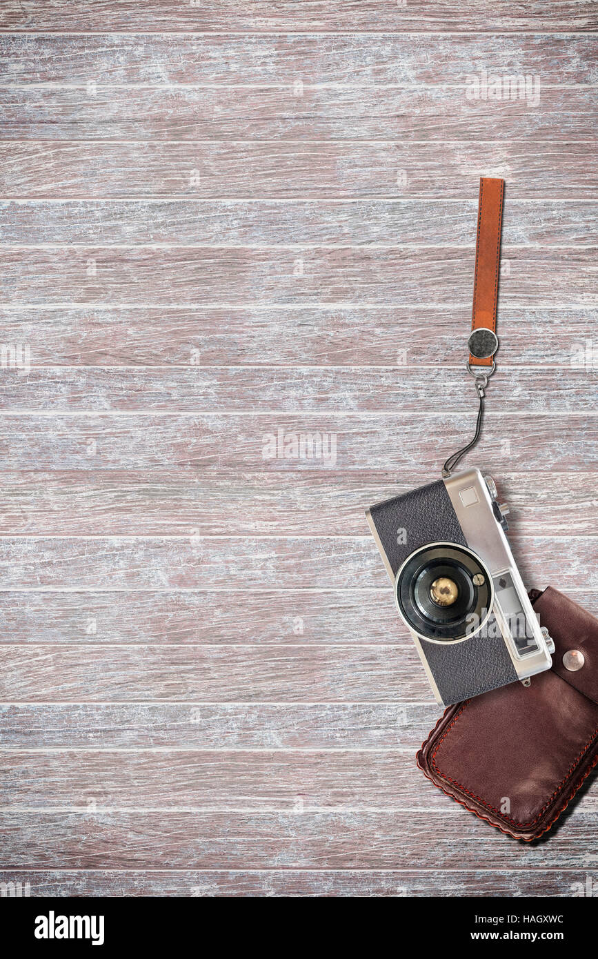 vintage camera and leather bag on wooden background. Stock Photo