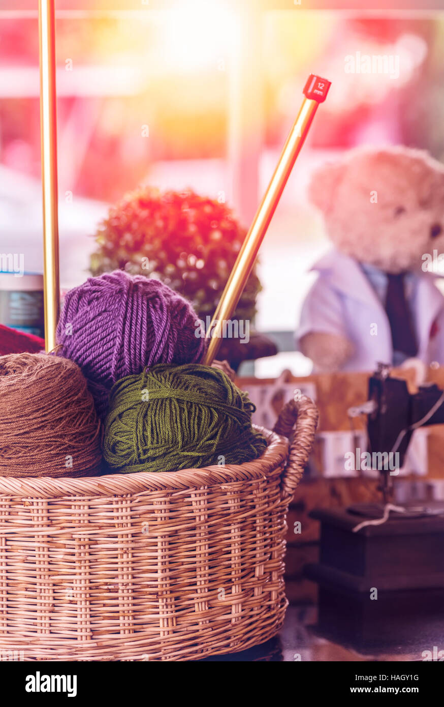 Knitting yarn balls and needles in basket Stock Photo