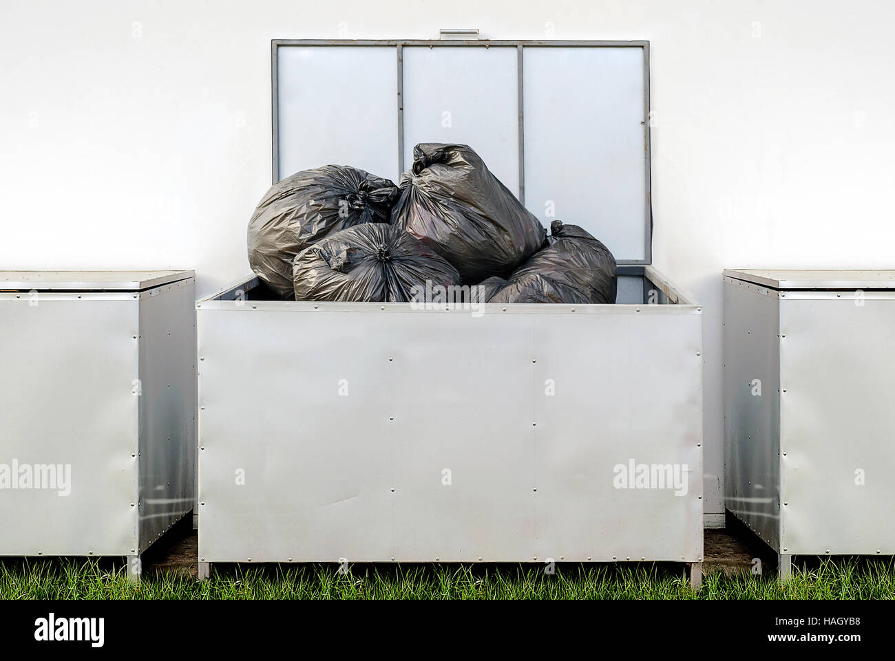 black garbage bags in  metal box out side the building. Stock Photo
