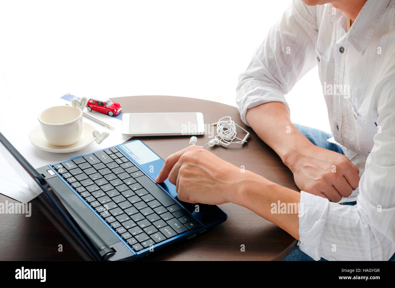 Side view of man using laptop with bright light background Stock Photo ...