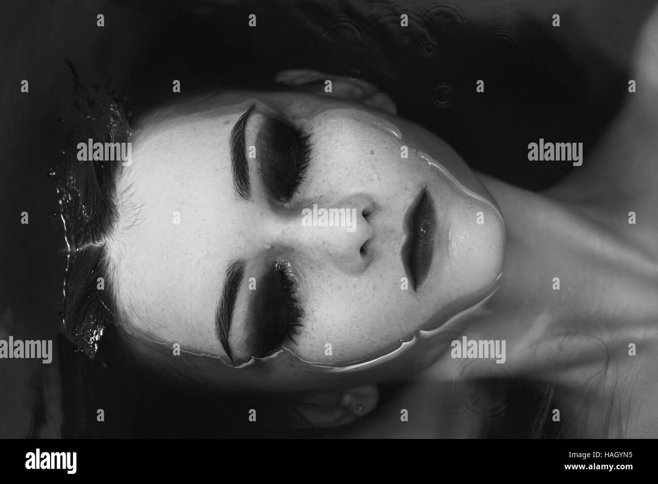 young beautiful woman lying in water, monochrome Stock Photo - Alamy