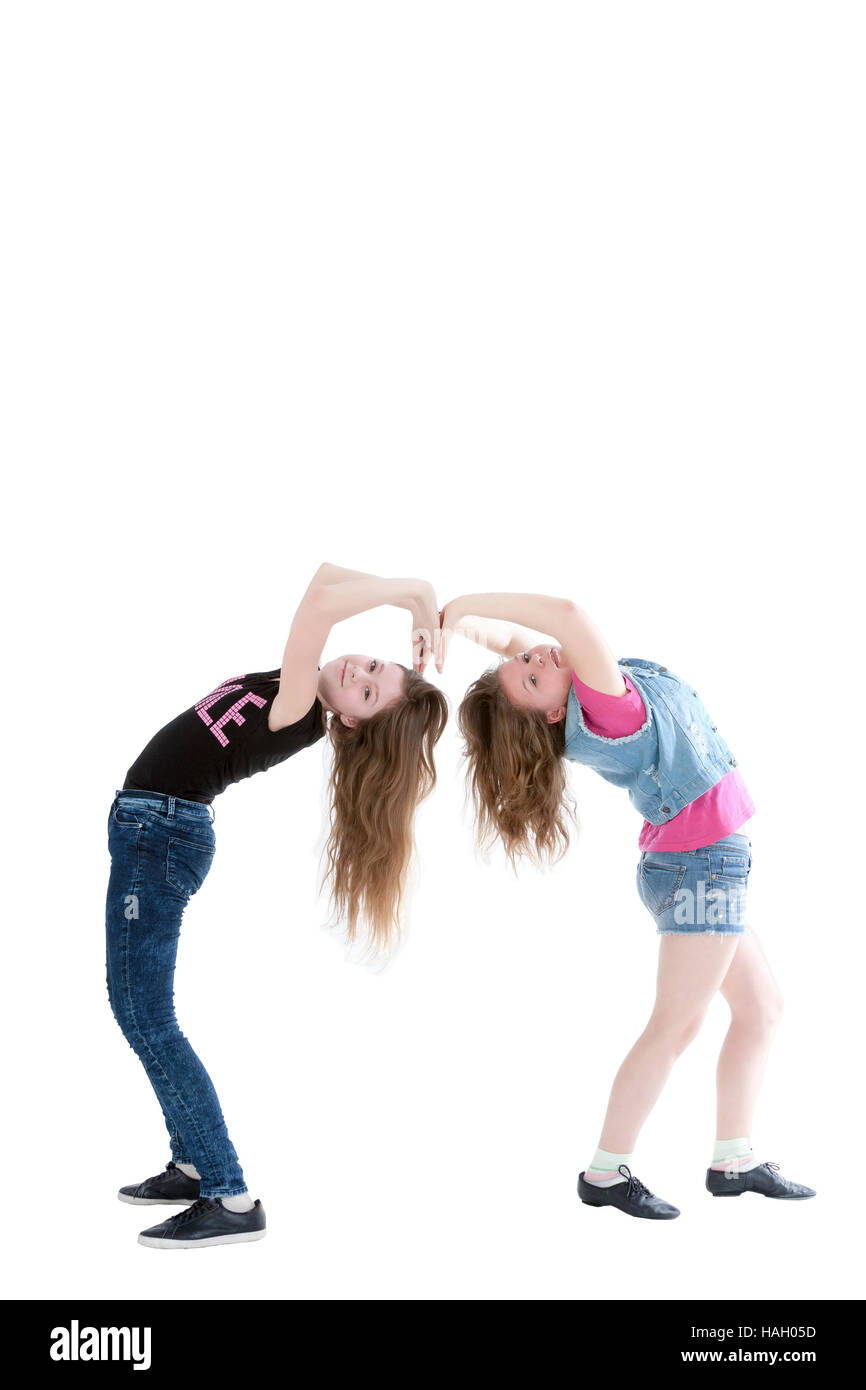 two smiling young beautiful girls on a white background Stock Photo - Alamy