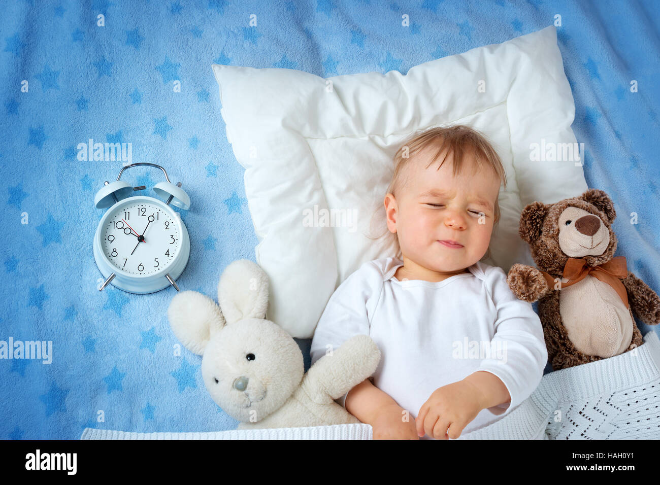One year old baby with alarm clock Stock Photo Alamy