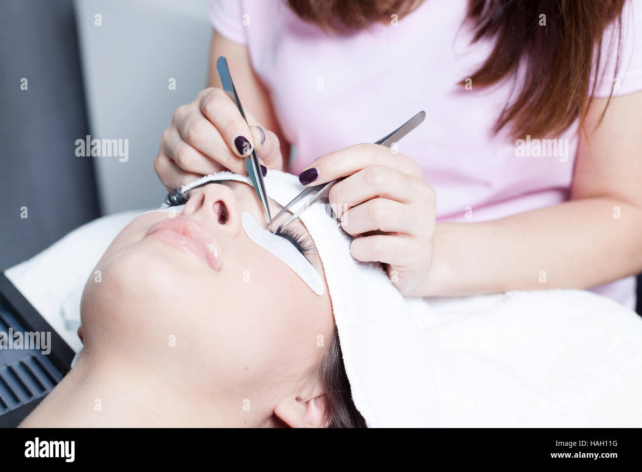 beautician making artificial lashes. eyelash extension procedure Stock Photo