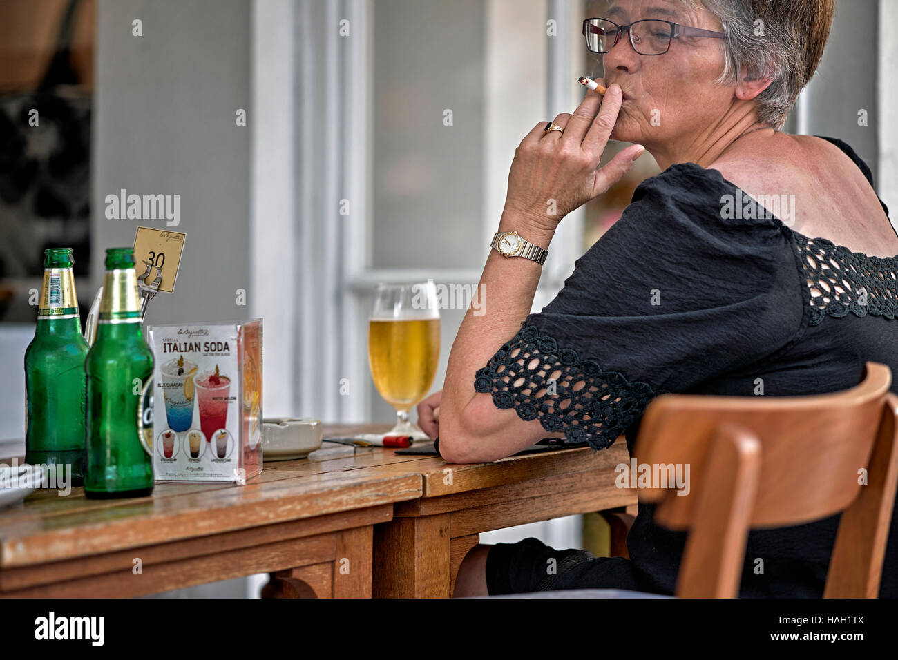 Mature woman smoking cigarette hi-res stock photography and images - Alamy