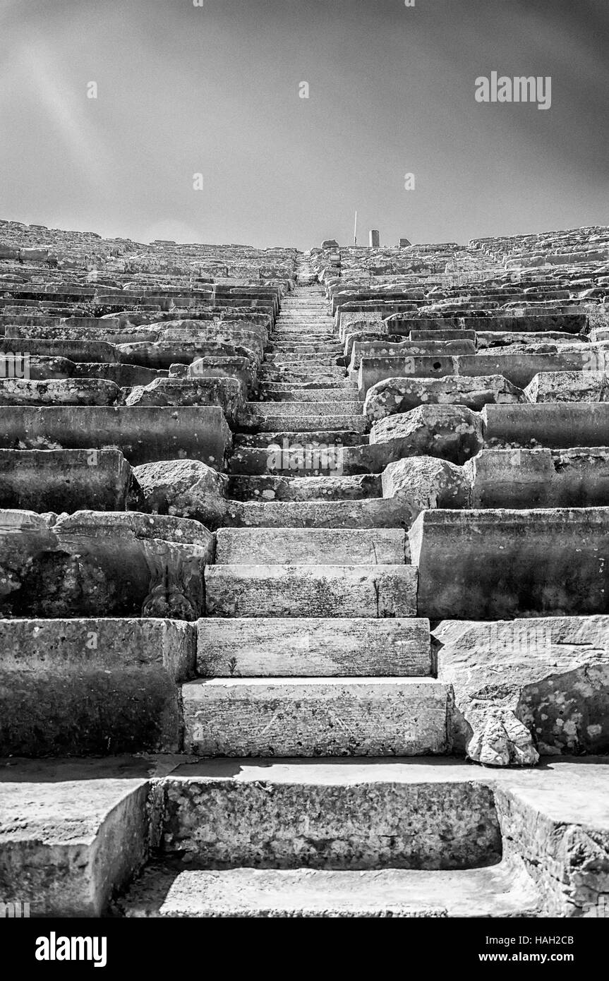 A black and white image of the ancient Roman amphitheatre situated in the turkish town of Side with added noise and contrast for dramatic effect. Stock Photo