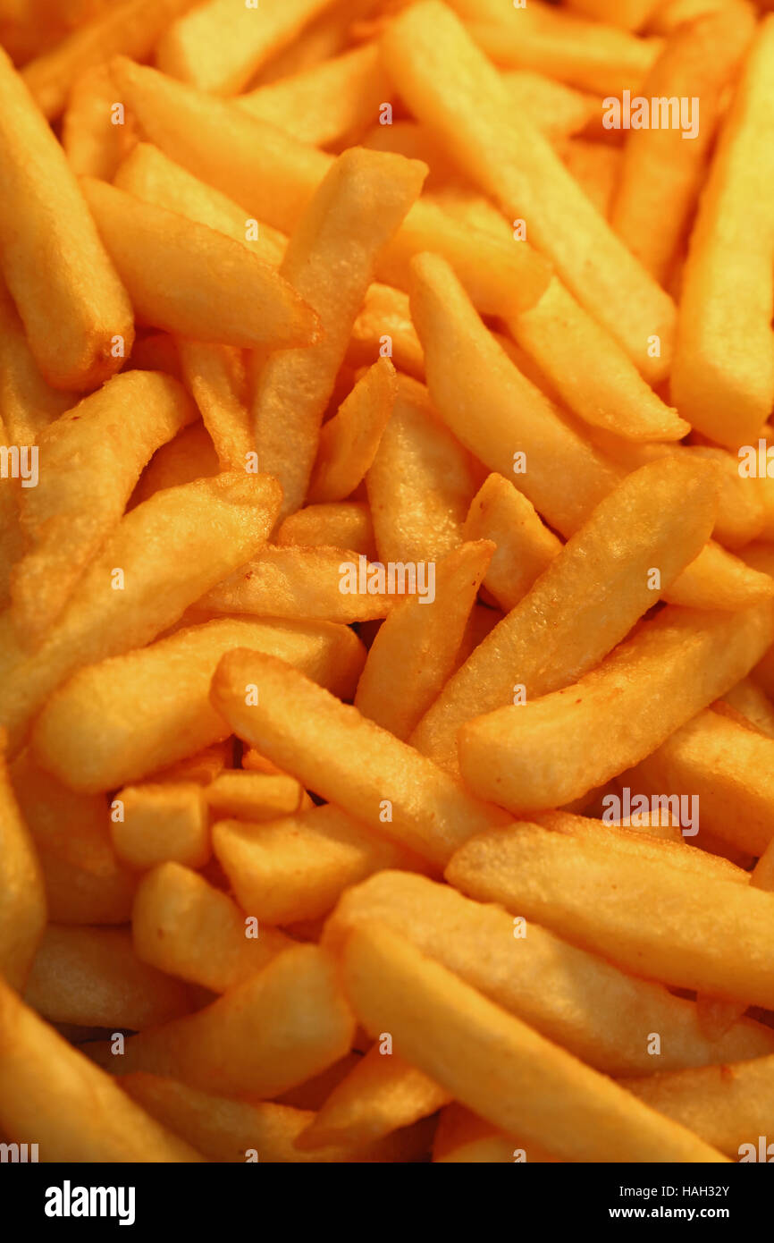 French fries, unhealthy deep fried potato chips close up, high angle