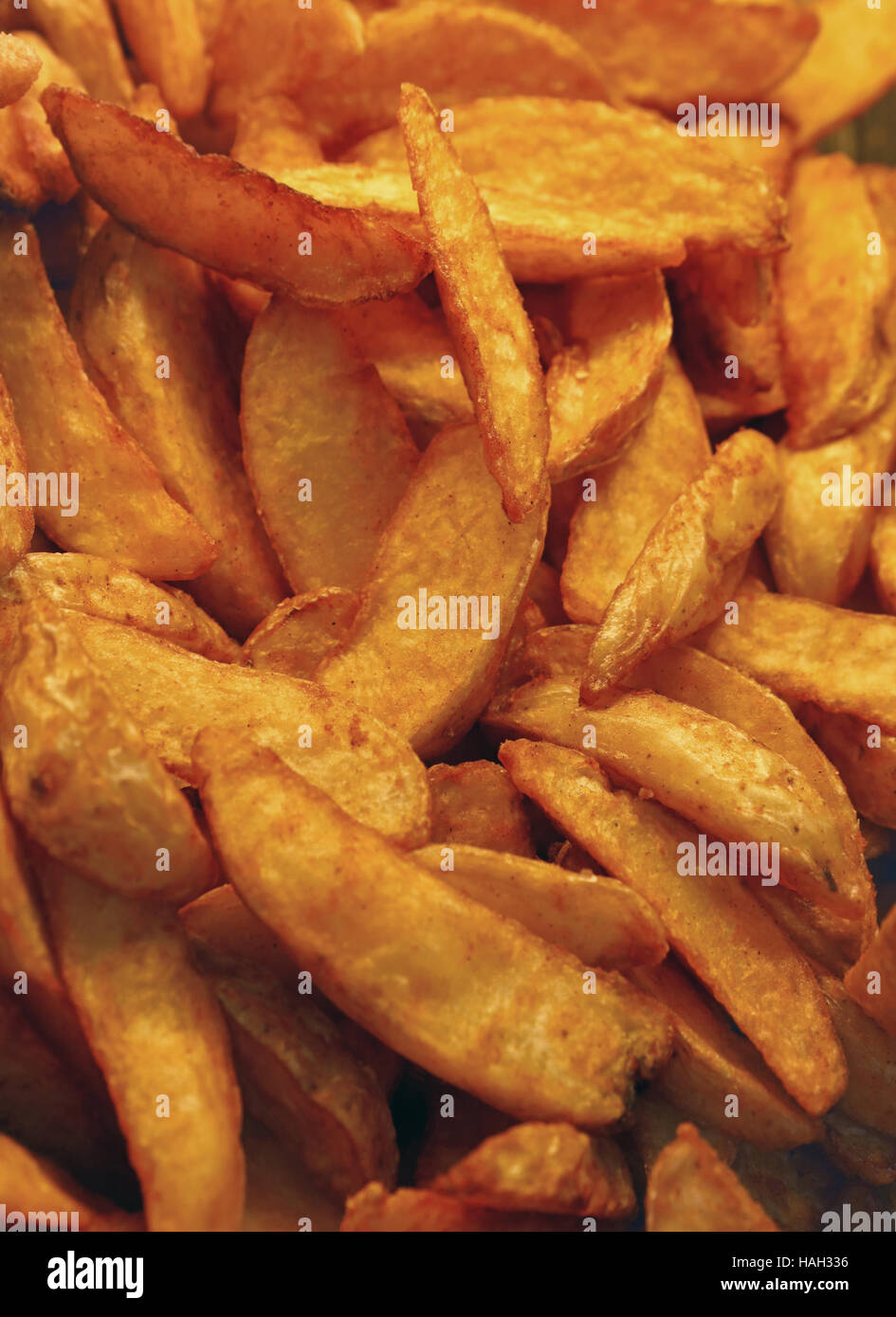 Unhealthy ready to eat deep fried potato or baked potato wedges chips