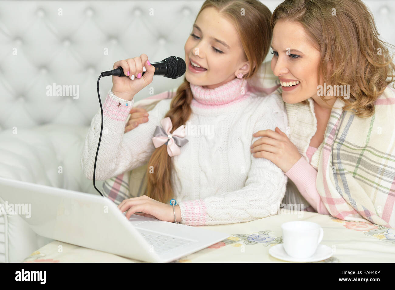 Mother and daughter singing karaoke Stock Photo Alamy