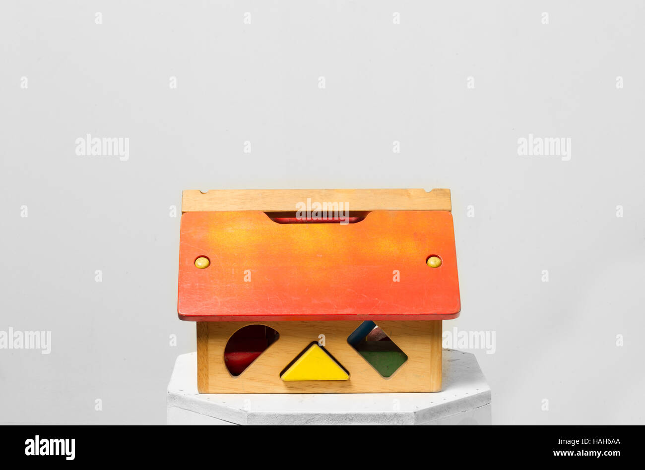 The house toy blocks isolated grey background, a little wooden home Stock Photo